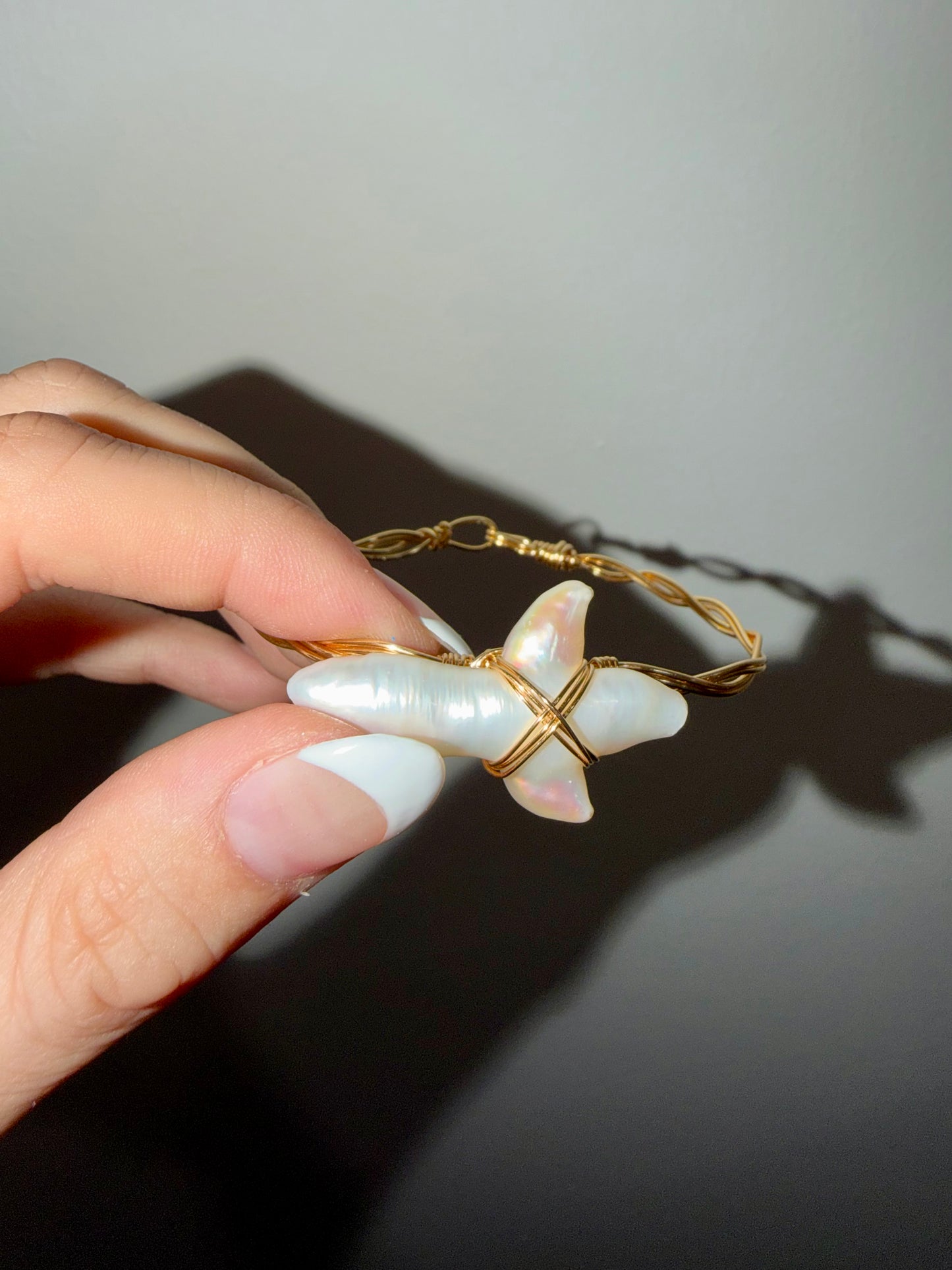 Large freshwater pearl cross gold plated wire bracelet